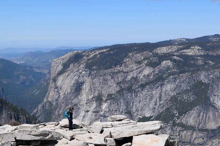 Standing at the top of Half Dome. Yosemite National Park, California.
